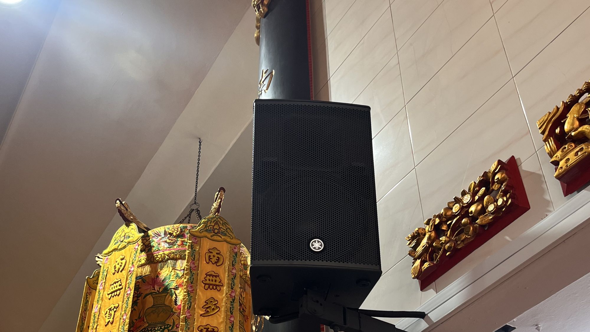 Yamaha loudspeaker installed beside gold ceremonial lanterns at Kuan Im Tng Temple, Joo Chiat, Singapore